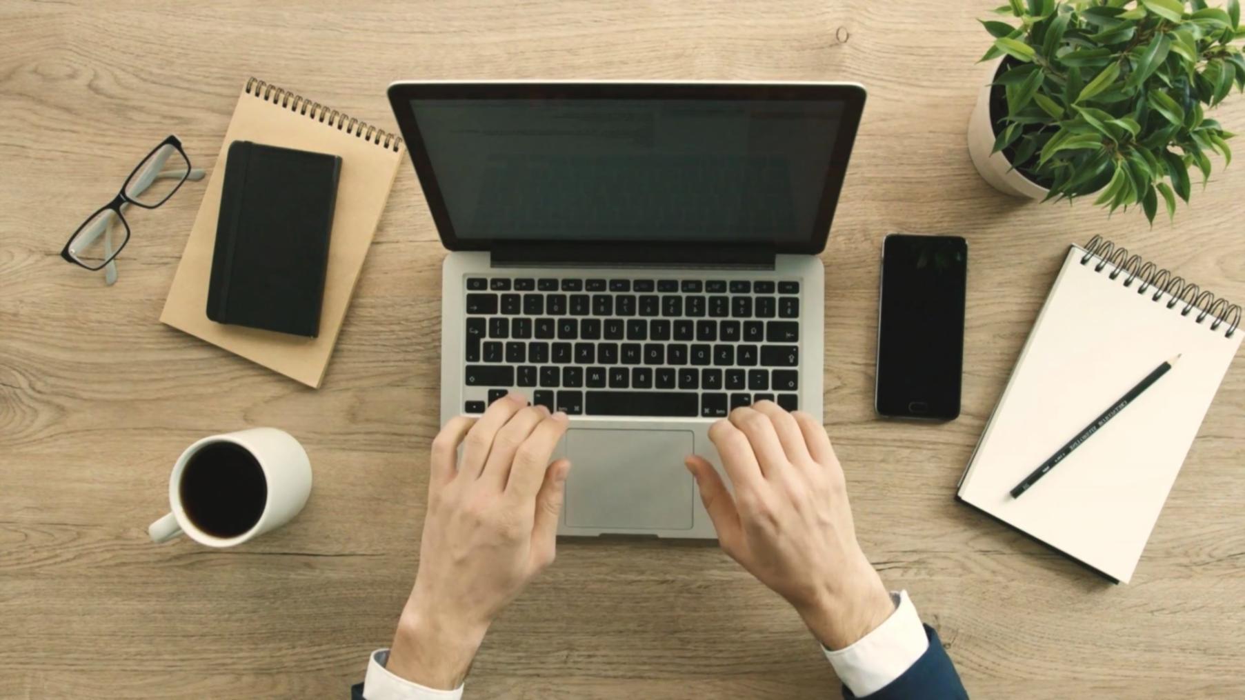 Compliance specialist analyzing customized reporting workflow on dual monitors
